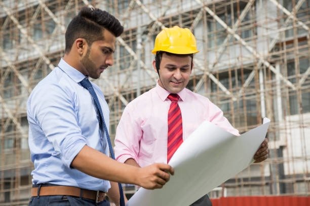 Site engineer discussing structural plan with client. RK Architect is the most trusted construction company in Jaipur.